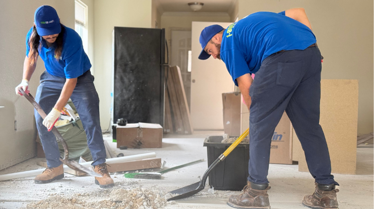 In-blog image 2 - Ruth 1-800-GOT-JUNK? truck team members shovelling renovation debris out of a customer's home