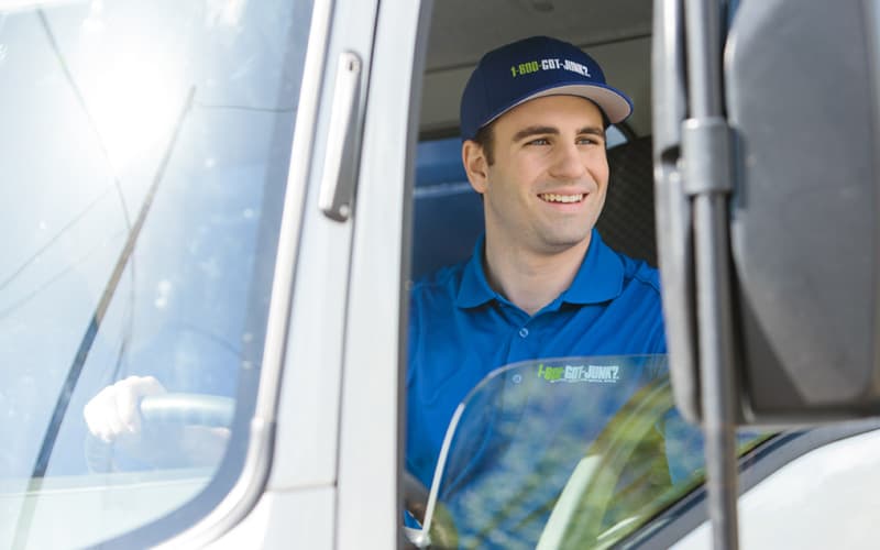 1-800-GOT-JUNK? team member in junk removal truck for residential services 1-800-GOT-JUNK? team member in junk removal truck for residential services