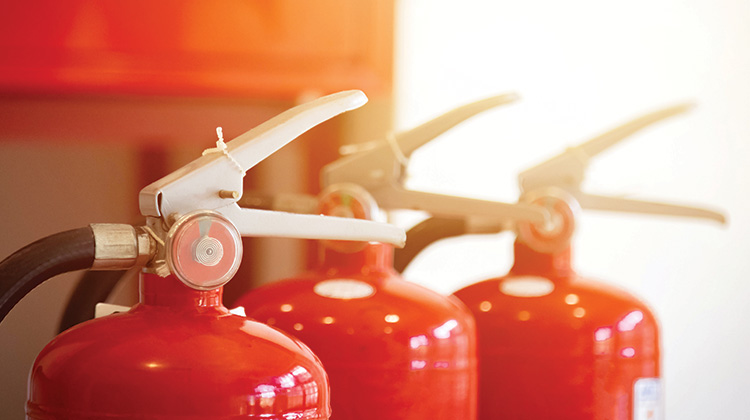 How to dispose of an old fire extinguisher Top of three red fire extinguishers lined up